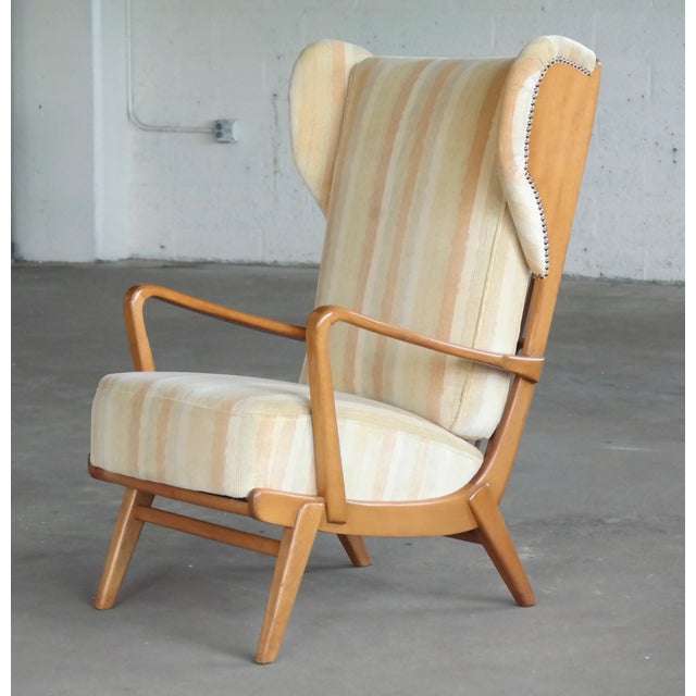 Ultra cool Scandinavian highback wing chair with exposed sides made from elm wood by an unknown maker around the 1950's....