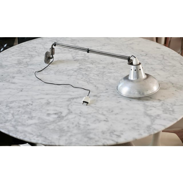 Georges Houillon wall light, France, 1950s Traces and pitting of weathered metal, small reflector shocks, structure in...