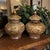A stunning pair of vintage porcelain lidded temple jars showcase the exquisite artistry of Japanese Satsuma. They feature...