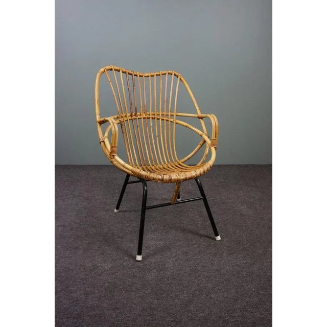 This not common rattan armchair made by Rohé Noordwolde in the 60s. This unique armchair was made in the 60s "in the...
