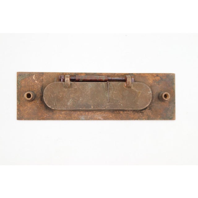 Vintage brass spring loaded mail slot that opens inward at 45 degrees to allow mail through. This is the cover plate only....