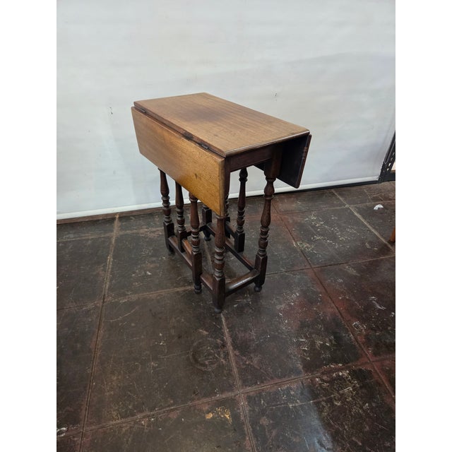 This is a charming Gate-Leg Table Brown Mahogany 18th Century with peg construction and in original finish. The leg area...