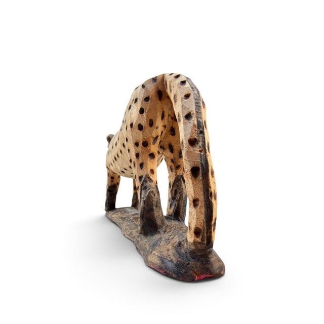Vintage hand-carved wooden leopard sculpture featuring an elongated walking form, expressive open mouth, curved tail, and...