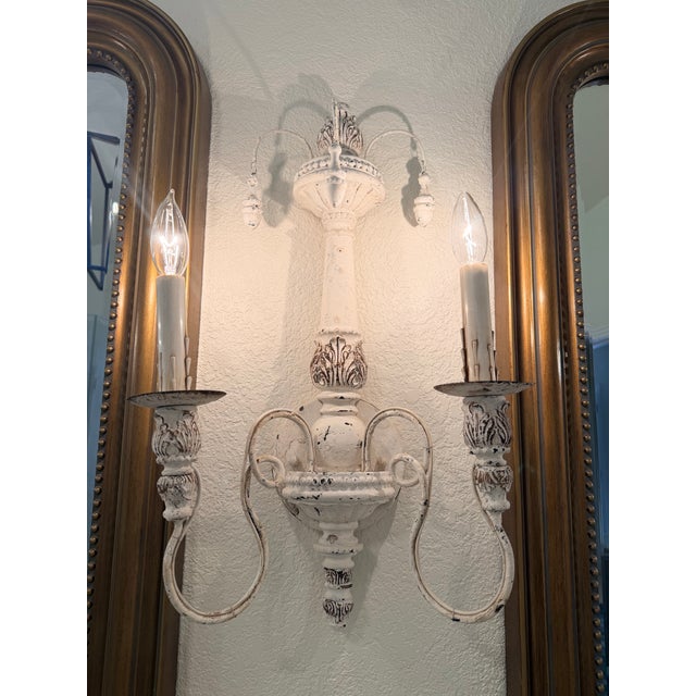 Bring timeless European character to your home with this elegant set of three hand-finished wall sconces, featuring a...