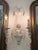 Bring timeless European character to your home with this elegant set of three hand-finished wall sconces, featuring a...