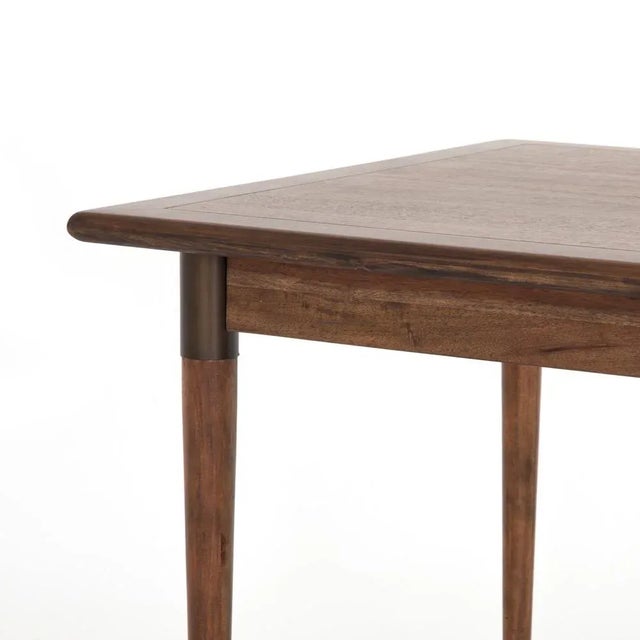 Style with flexibility. Finished in a warm toasted walnut, a rectangular acacia tabletop, cone-tapered legs and iron...
