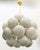 Italian sputnik chandelier with 24 cream Murano pebble glass shades mounted on brass frame in unlacquered natural brass...