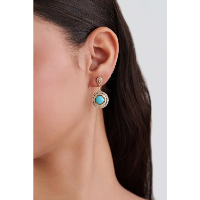 These elegant drop earrings feature 3.07 carats of vibrant turquoise cabochons, 14K yellow gold. Each measuring 8 mm in...