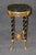 This exceptionally elegant Louis XVI-style occasional table, in the manner of Adam Weisweiler, combines the restrained...
