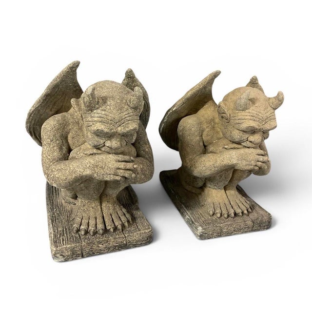 This striking pair of vintage gargoyle statues features two crouched, contemplative figures with expressive faces, small...