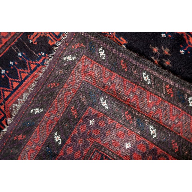 An exceptional Antique Afghan Baluch Rug hand-knotted by nomadic weavers in Afghanistan, dating to the early 20th century....