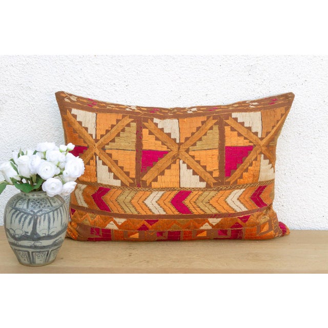 This lumbar pillow is a profound example of Museum-Grade Phulkari, repurposed from a rare 19th-century Heirloom Bagh....