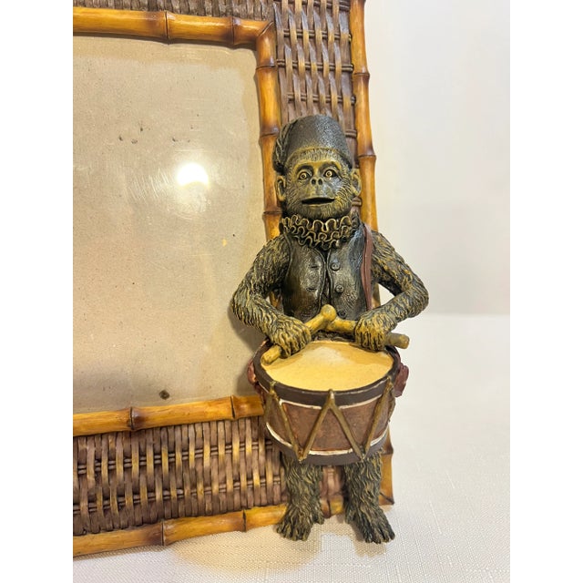 Welcome to Turtle and Crane! This Vintage Palm Beach Regency Style Monkey Drummer Picture Frame is a truly captivating...