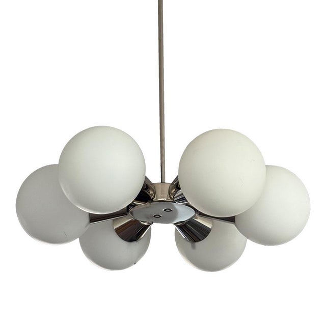 A stylish Sputnik chandelier inspired by the space-age aesthetics of the 1970s, likely produced in Kamenický Šenov. The...