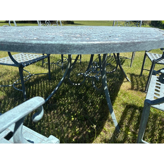 This is a handsome cast aluminum garden set with six chairs. This cast aluminum set has beautiful scroll work on the top...
