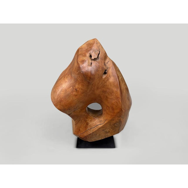 Minimalist sculpture hand carved from a single block of century old teak wood. Finished with a natural oil revealing the...