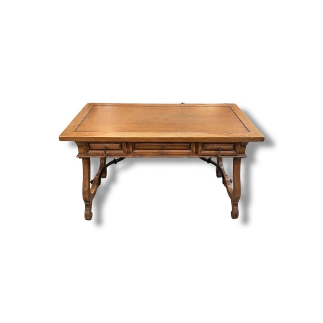Beautiful vintage three-drawer desk crafted in warm-toned wood with classic carved legs and timeless detailing. The...