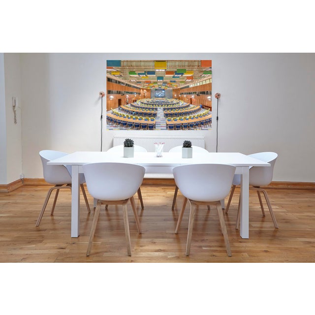 The Trusteeship Council Chamber is a horseshoe-shaped room with a high ceiling. The walls are decorated with murals...