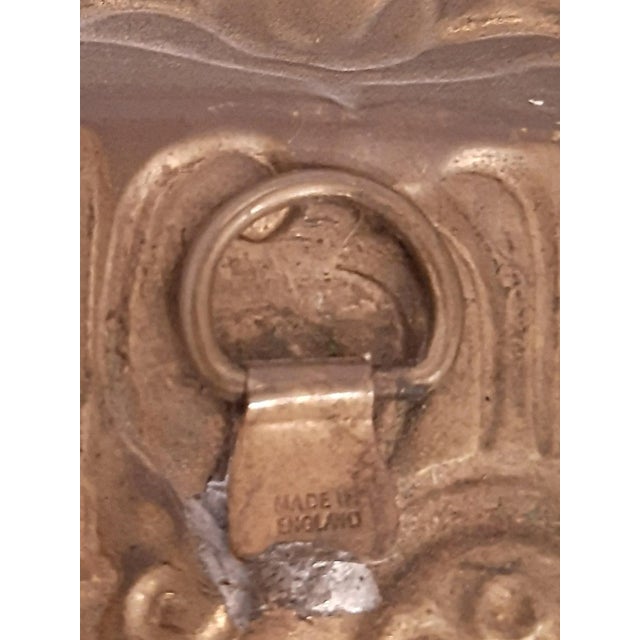 Branded "Made in England," this extra-large brass wall plaque features a scene of a maid and a gentlemen at a bar or...