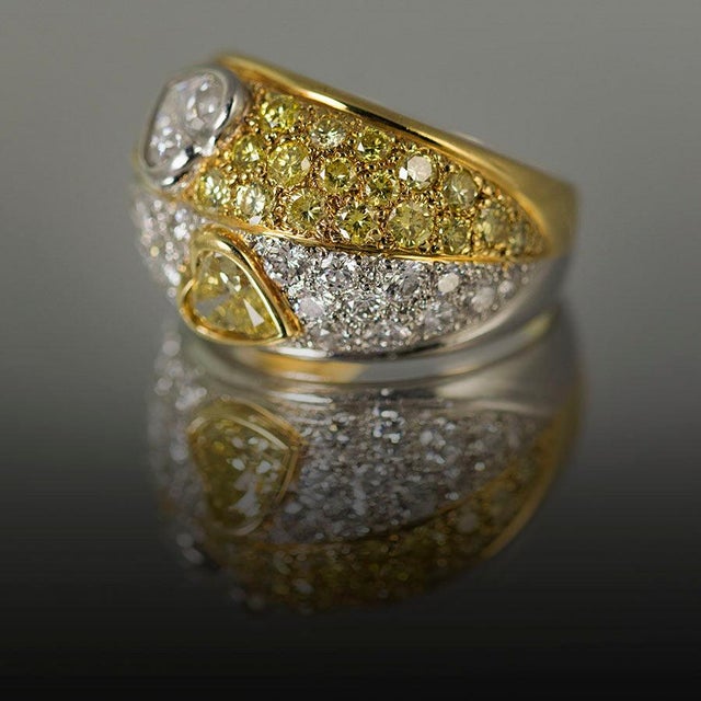 Platinum & 18k Ring by Keith Davis, with GIA certified Fancy Intense Yellow diamonds weighing 1.92 carats and white...