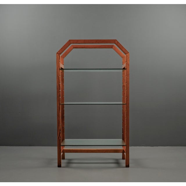 Geometric design featuring simple frame components made of solid pinewood, combined with three clear glass shelves. The...