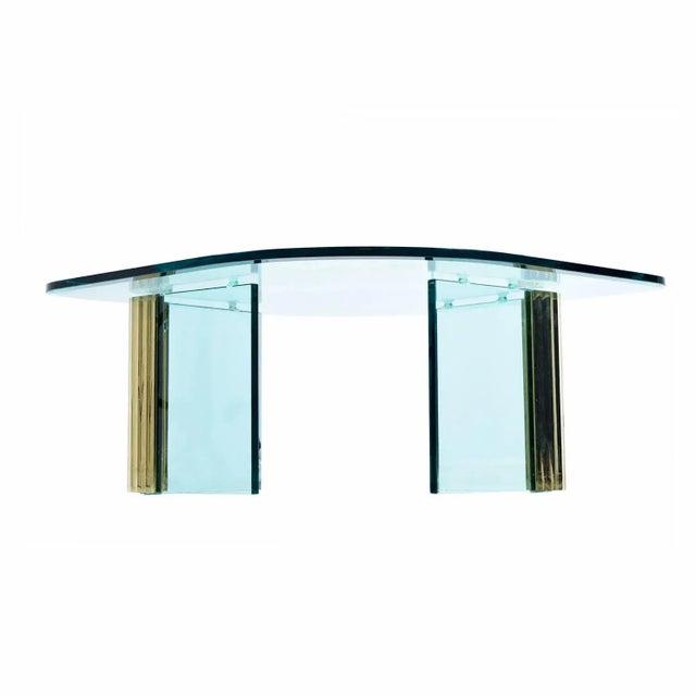 Rippled / scalloped brass pillars hold 3/4″ blue tinted vertical glass sheets to create a sturdy foundation for the...