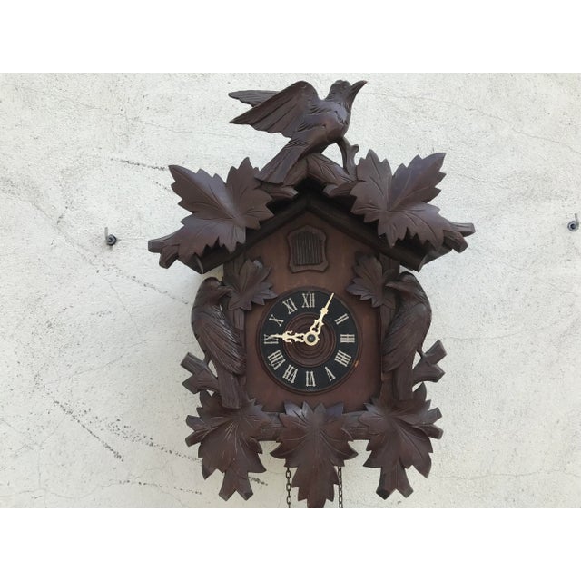 Carved big cuckoo clock with birds and leaves, 1930s. Vintage design. Woodland carved wooden cuckoo clock with birds....