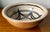 This wonderful handmade studio art pottery large bowl features geometric motifs on a natural ground and Brown glazed...
