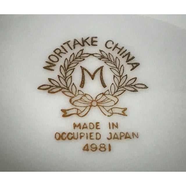 Timeless Noritake Valiere features a sophisticated design with a black and gold edge, a cream band, and delicate gold...