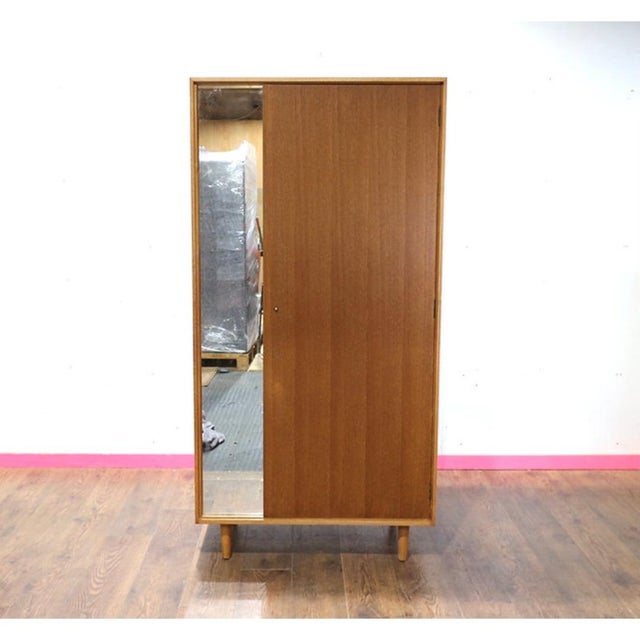 Discover the elegance of a gorgeous mid century armoire made by renowned British furniture maker Stag. This vintage teak...