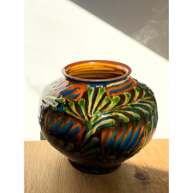 Glazed earthenware vase with botanical slip-trailed decoration, dating to around 1920. Marked HAK, from Herman A. Kähler’s...