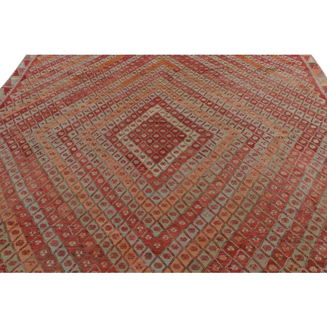 Handwoven in Turkey originating between 1950-1960, this vintage midcentury wool Kilim hails from the town of Sarkisla...