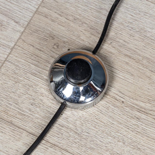 A lovely “space age“ floor lamp made in italy in the 1970s. The heavy chrome base supports two semicircular chromes cups...