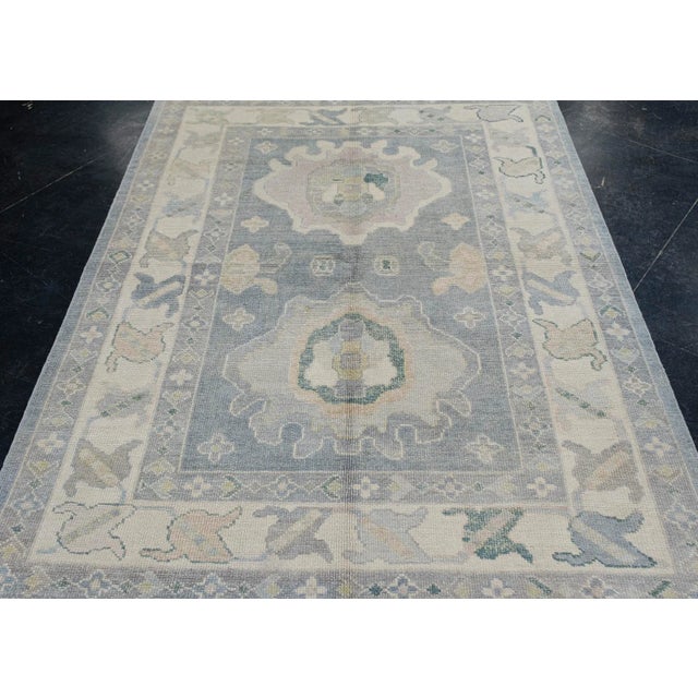 Turkish Oushak Rug Faded Blue Ivory Handwoven Wool Rug 5'5" X 7' This 5'5" x 7' Turkish Oushak rug showcases timeless...