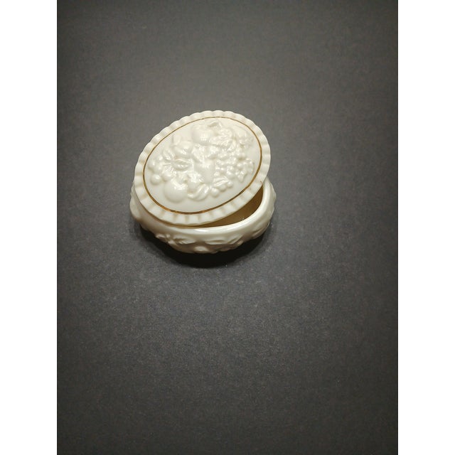 This Lenox Trinket Dish is a traditional style piece with gold detailing and a fruit motif, manufactured in China in 1998....