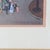 This framed print by renowned French artist Michel Delacroix captures a bustling Parisian street scene, characteristic of...