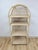 This gorgeous vintage arched blonde rattan lattice etagere is a warm and beautifully crafted coastal and boho display...