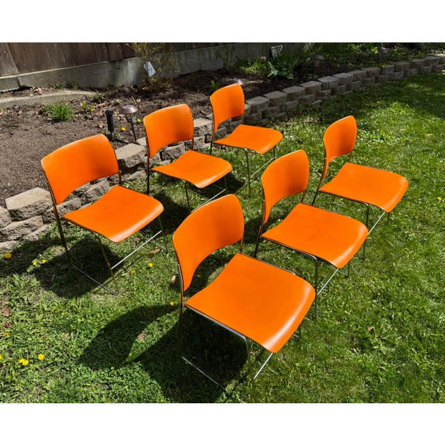 Set of six 40/4 chairs designed by David Rowland. Orange painted metal seats and backs with steel rod frames. Clean,...