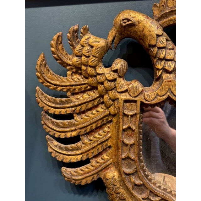 19th century Italian giltwood crest. Featuring elaborate carvings and a mirror in the middle. An elegant piece! Circa 1880...