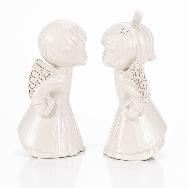Sweet and collectible vintage porcelain angel figurines sold as a matching set of two: one boy and one girl. Finished in...