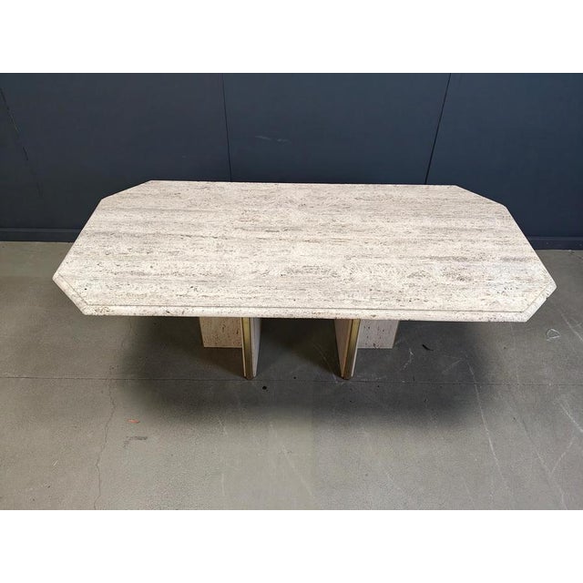 Vintage travertine dining table with two brass and travertine bases. The combination of brass and travertine makes the...