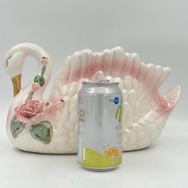This vintage lusterware swan planter showcases a beautiful iridescent finish. It features pink accents, a gold beak, and...