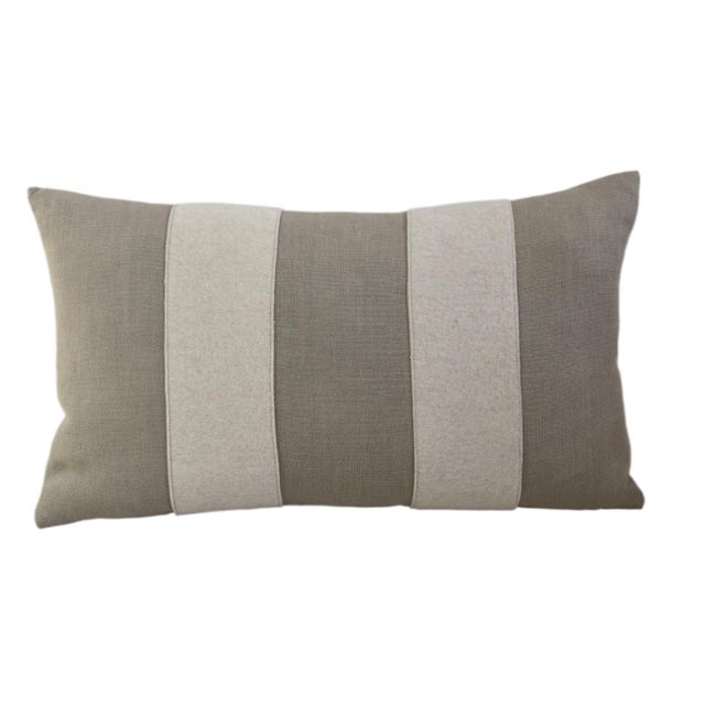 Custom-tailored pillow created from a taupe linen textile. Pillow has two cream-colored wool appliqué stripes on the...