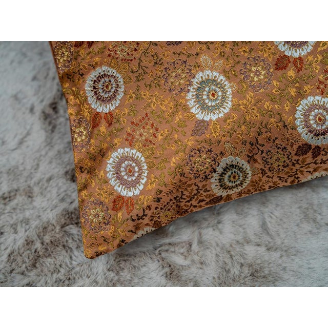 Kiku in autumn copper. The chrysanthemum — the queen of flowers — set in floating medallions across burnished copper silk,...
