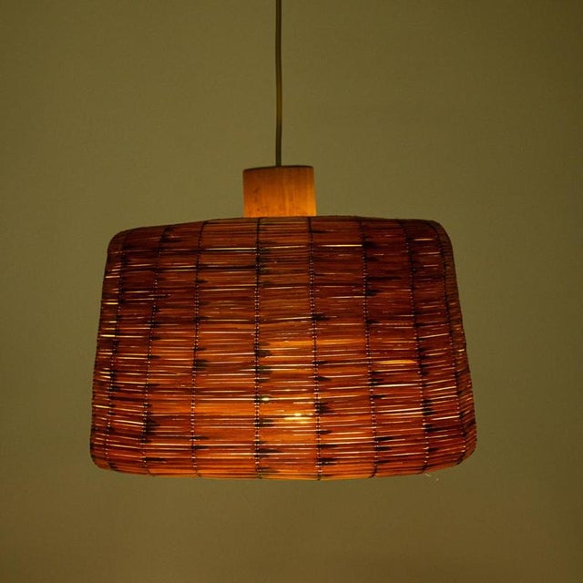 Wicker chandelier, probably from the 1970s. The shade is made of interwoven straw, so when lit it creates a pleasant dim...