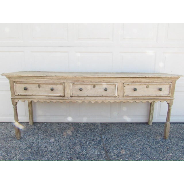 Antique English weathered and bleached out oak dresser base or console table, c.1800 Having a molded rectangular top with...