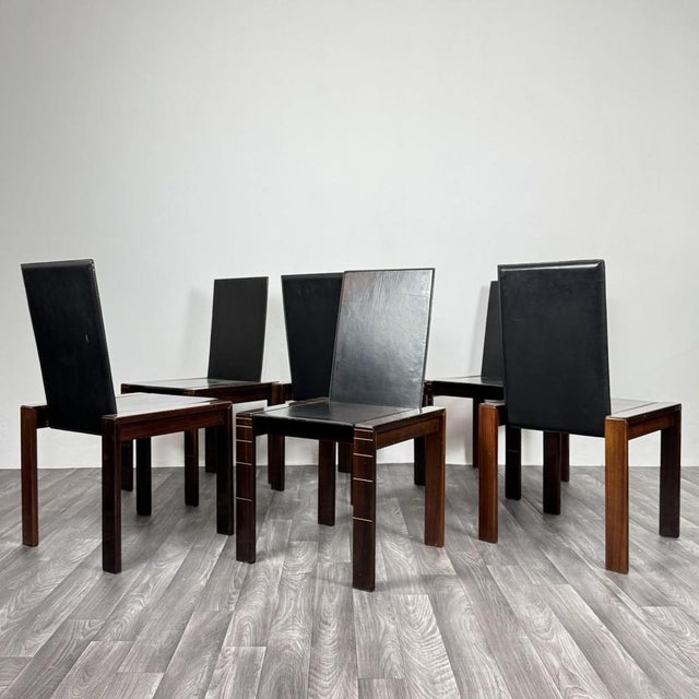 Elegant set of six 1970s chairs with a strong geometric character and timeless appeal. Rosewood frames, with clean,...
