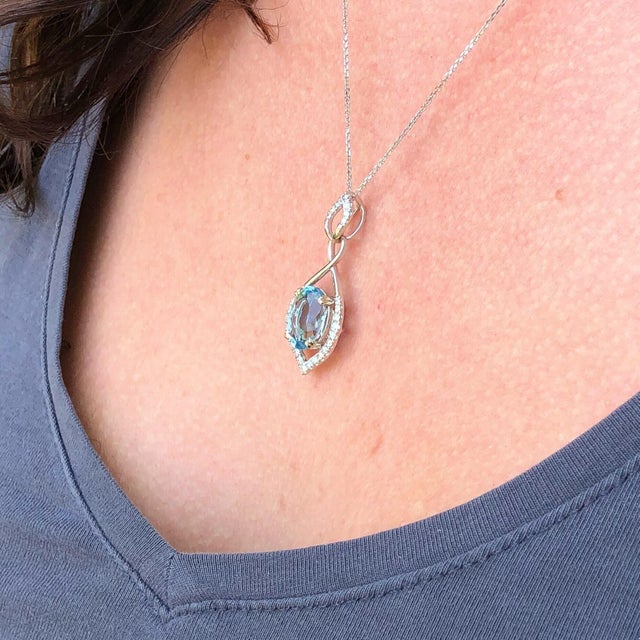 This beautiful pendant features a stunning 3ct sea blue oval aquamarine with natural earth-mined diamonds in solid 14k...