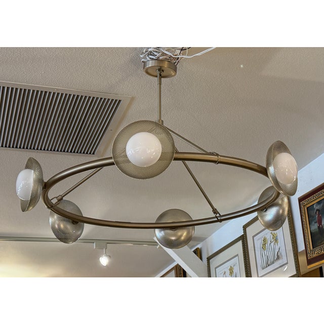 Design Plus Gallery presents the Champagne Bronze Bezel Circle Chandelier from West Elm. This round light fixture has...