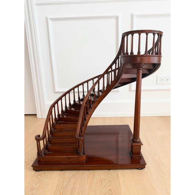 An impressive vintage mahogany architectural staircase model featuring an elegant sweeping staircase, gracefully curved...